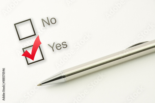 questionnaire: yes no choice, marked check box with a pen on paper background. Approval concept