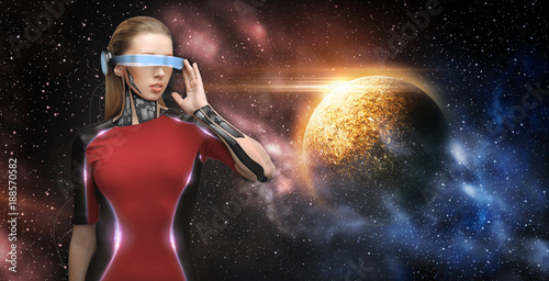 female robot in virtual reality glasses over space