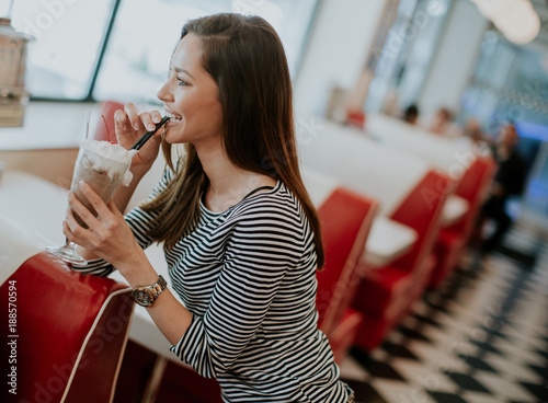 Woman drinks  milkshake at ...