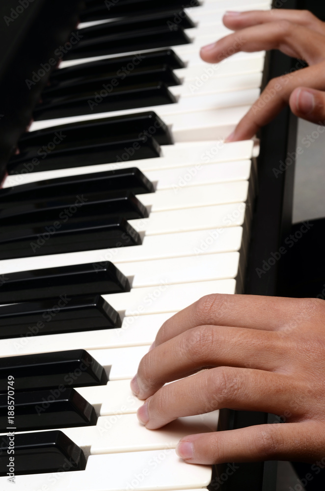 Child hands on piano keyboard Child hands on piano keyboard