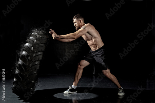 Crossfit training - man flipping tire © Andrey Burmakin