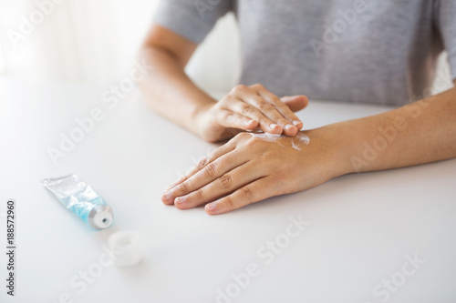close up of hands with cream or therapeutic salve