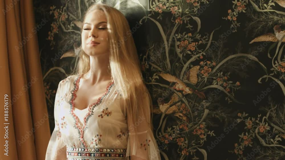Beautiful blonde with long hair in a dress in stylish intreire Beautiful blonde with long hair in a dress in stylish intreire