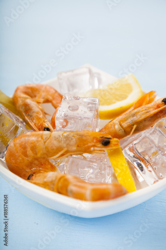 Fresh shrimp with lemon on ice