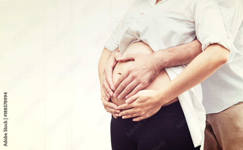 Cluse Up Beautiful Pregnant Woman and Husband Hugging the Tummy with Love - Family Concept - obrazy, fototapety, plakaty 