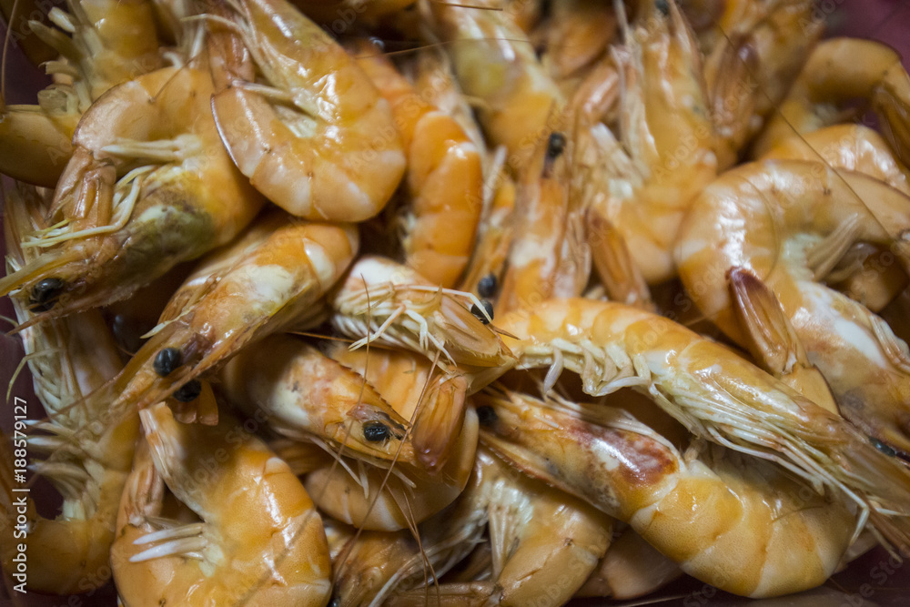 Cooked shrimp, detail on an orange background. Cooked shrimp, detail on an orange background.