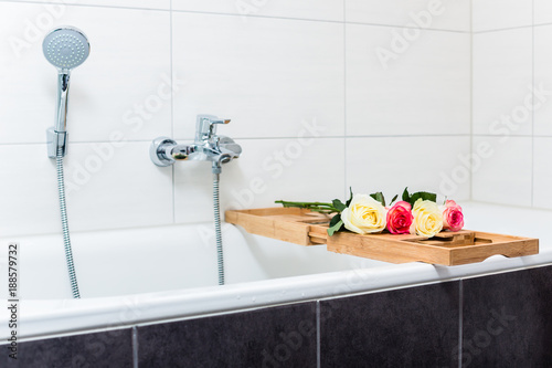 Bathtub with relaxation arrangement of flowers and candles