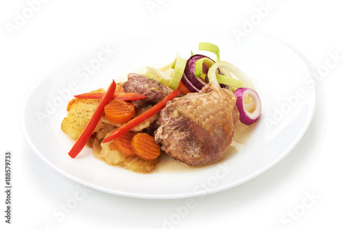 Baked turkey meat with sliced vegetables, isolated on white background.
