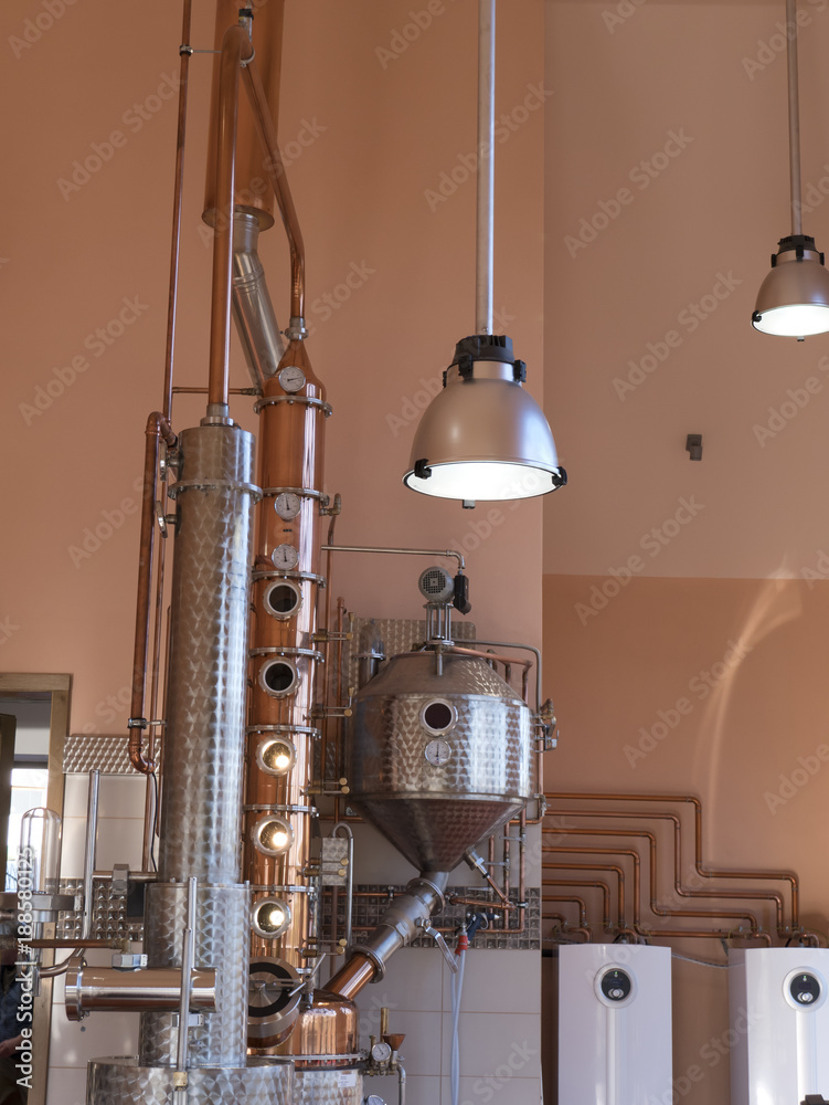 alembic still for making alcohol inside distillery, destilling spirits