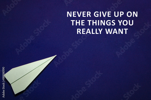 colored paper plane on a dark blue background. Teamwork concept. Never give up on the things you really want