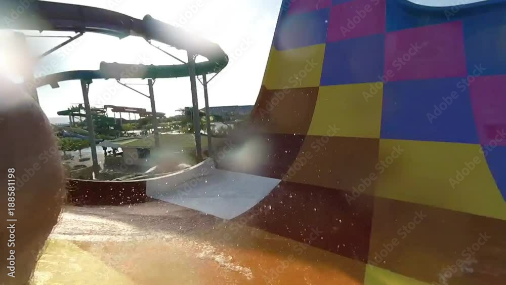 POV point of view. A young man slides down a water slide at the water Park.