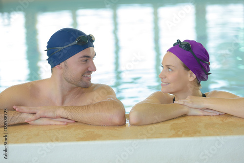 couple in the pool with swimming cap