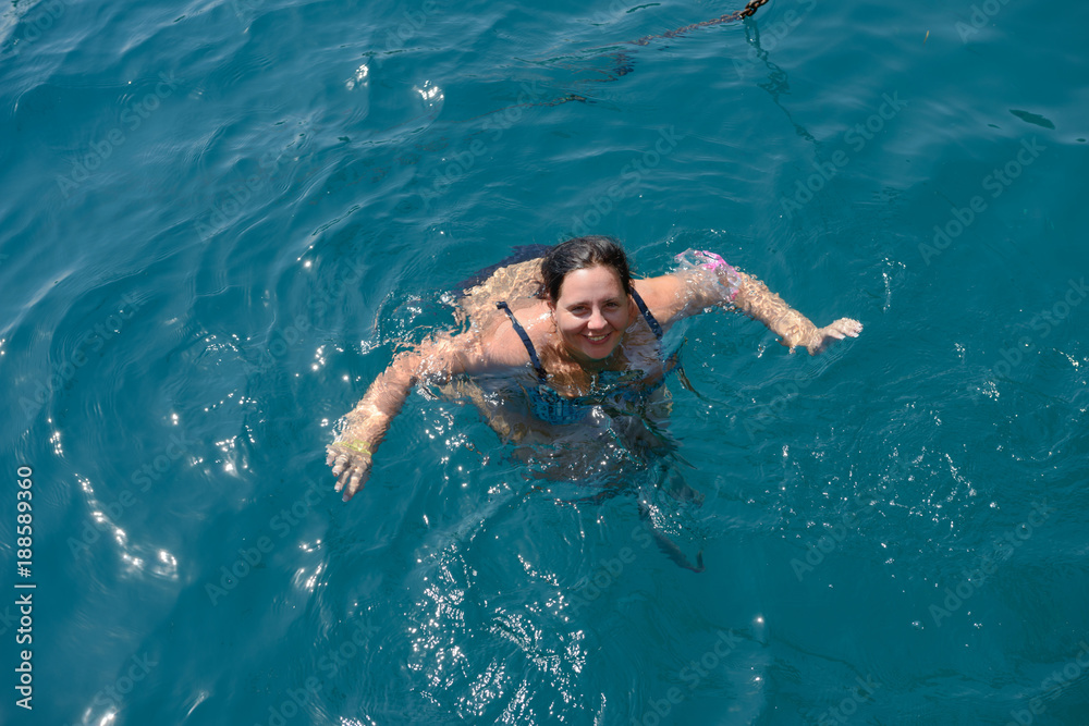 High angle view of young woman swimming in the sea.