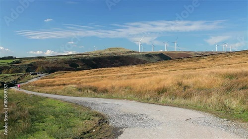 Jogger & Wind Turbines On Moor; Naden Lower Reservoir; Near, Wolstenholme, Lancashire photo