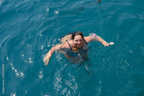 High angle view of young woman swimming in the sea.