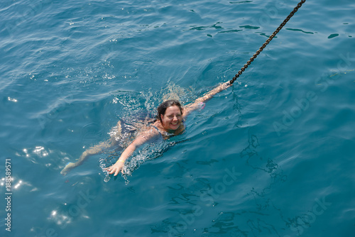 High angle view of young woman swimming in the sea.