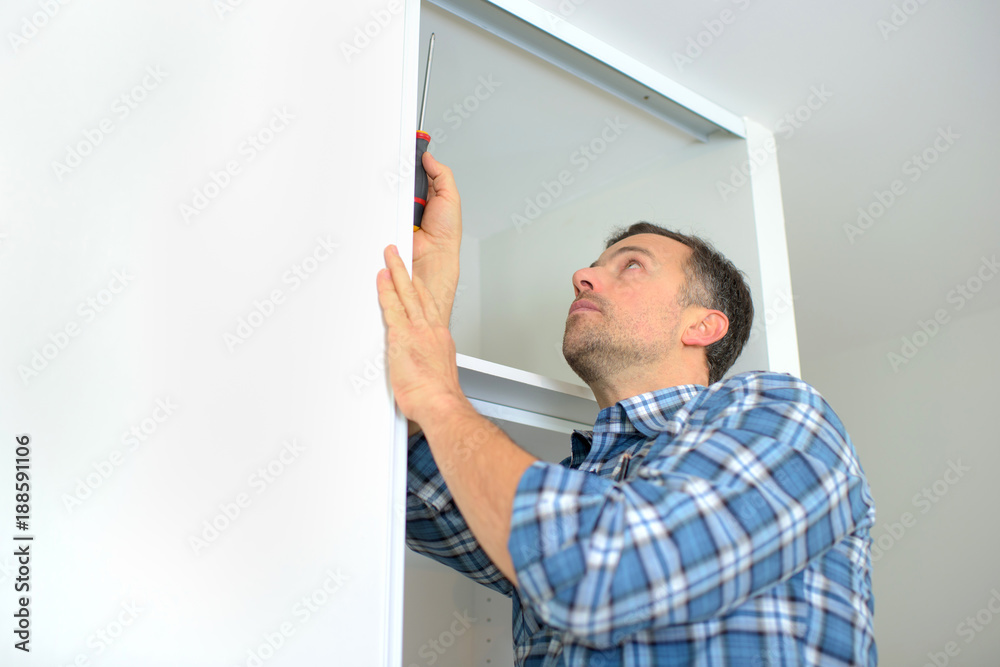 Carpenter installing a wardrobe
