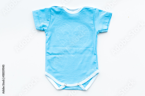 Baby clothes. Blue bodysuit for little boy on white background top view © 9dreamstudio