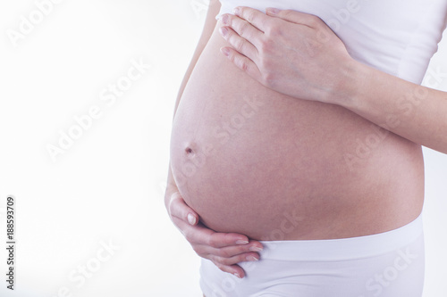 The picture of baby bump isolated on white background. The happiness of waiting for a new family member.