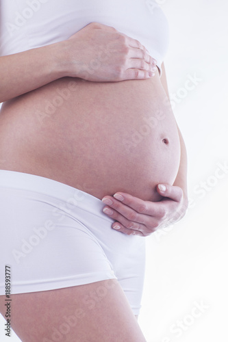 The picture of baby bump isolated on white background. The happiness of waiting for a new family member.