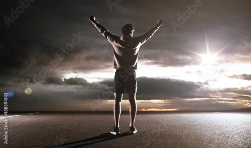 Portrait of an athlete looking at the dark clouds