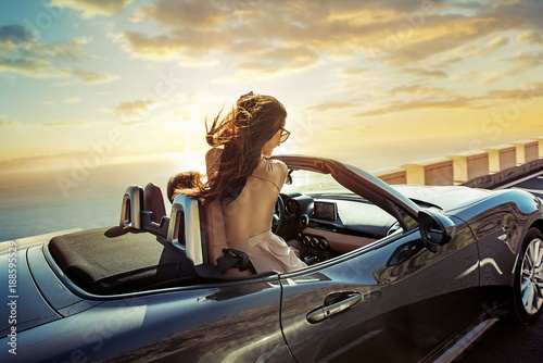 Relaxed couple riding a convertible