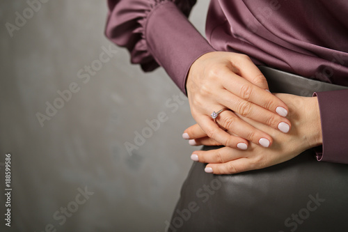 Closeup view of female hand with engagement diamond ring on finger
