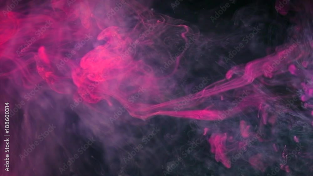 Abstract purple neon flowing ink in water over black background. Dropping colorful ink into the water. Slow motion 4K UHD video footage. 3840X2160