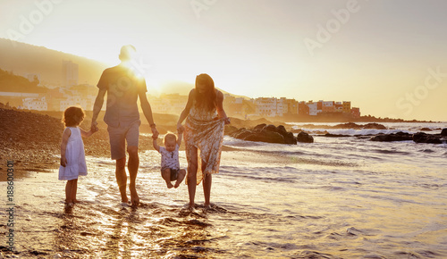 Cheerful family having fun on a beach, summer portrait photo