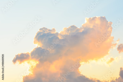 white fluffy clouds in the clear blue sky in a bright orange sunset