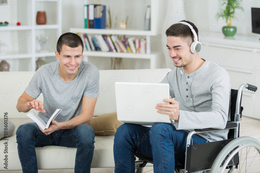 two male students going over their homework two male students going over their homework