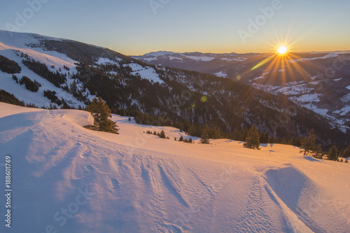 Sunrise in the Carpathian mountains in Transylvania , Romania, in a cold winter day with valley and hills in the background © Calin