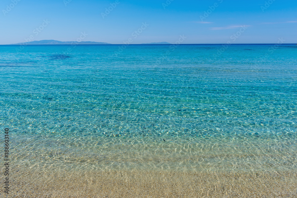 Crystal blue waters at Mikri Vigla beach on Naxos island, Cyclades, Greece