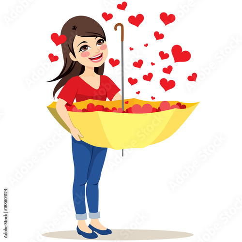 Beautiful young woman capturing falling red hearts rain with big yellow upside down umbrella love concept