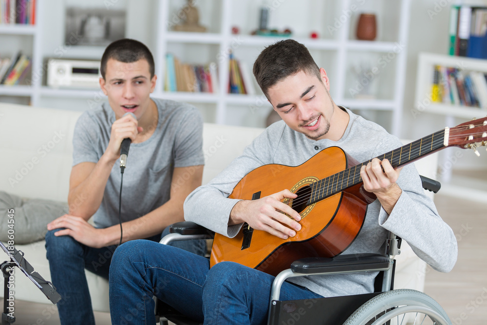 Young men playing guitar and singing Young men playing guitar and singing