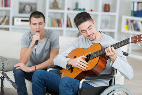 Young men playing guitar and singing