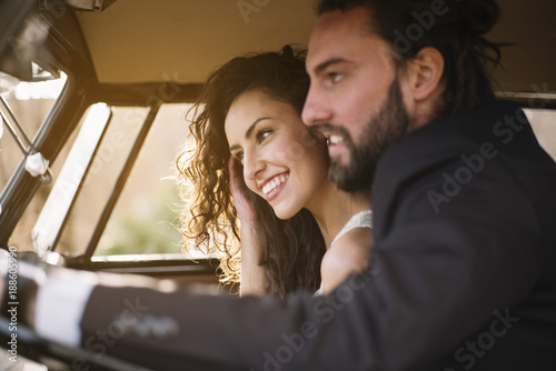 Happy young couple sitting in van