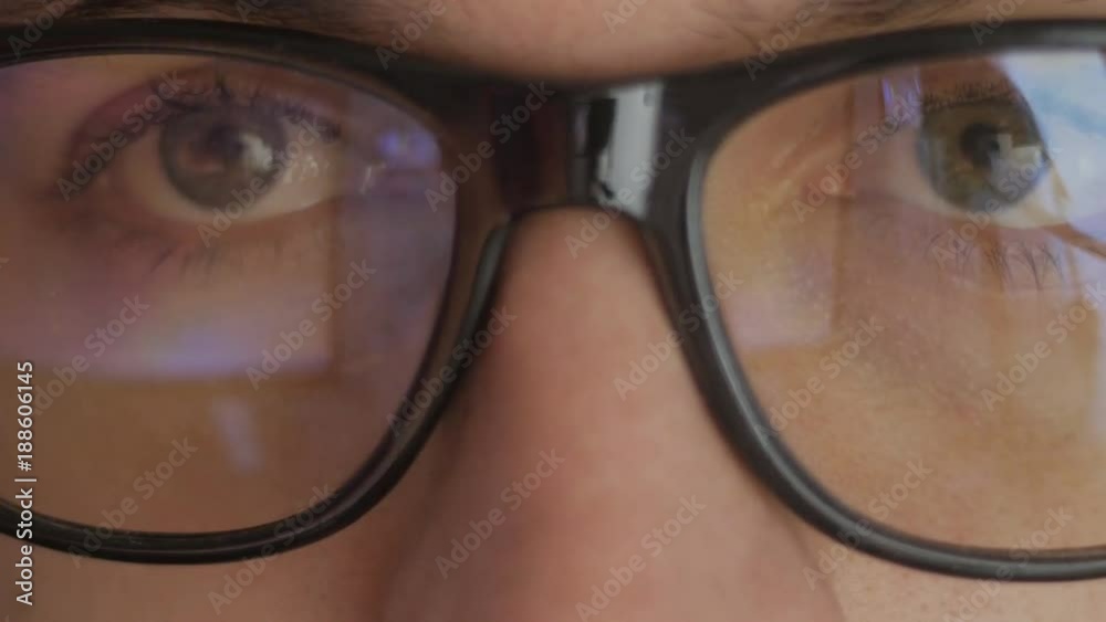 custom made wallpaper toronto digitalClose-up reflection in glasses of a man watching a movie. Double exposure of the guy watching the video. Macro