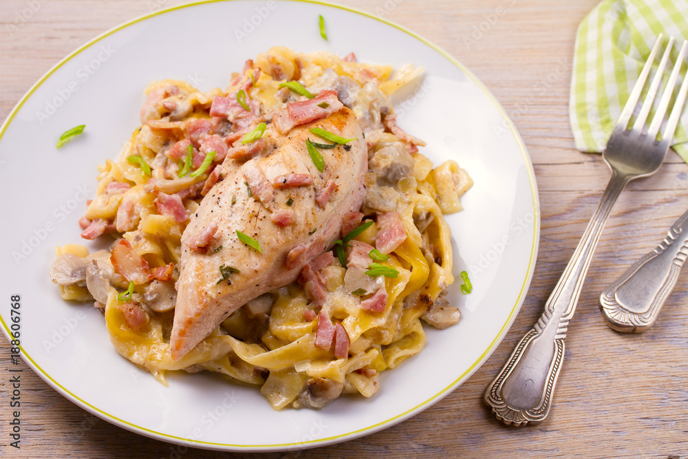 Chicken breast and egg noodles with bacon and mushrooms in creamy sauce. horizontal Chicken breast and egg noodles with bacon and mushrooms in creamy sauce. horizontal