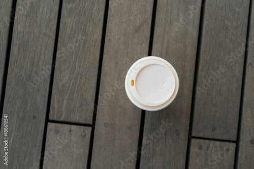 Top view of single hot latte on vintage wooden floor at relaxing balcony.