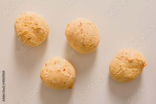 Pao de Queijo is a cheese bread ball from Brazil. Also known as Chipa, Pandebono and Pan de Yuca. Snacks over white background, minimalism. photo