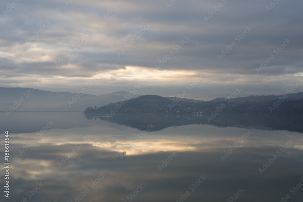 Grey winter lake mirror reflection