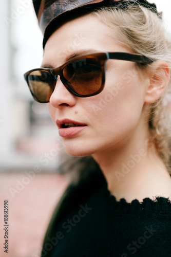 Closeup portrait of odd bizarre kinky beautiful cute young famous celebrity fashion caucasian blonde model woman in rich modern trendy sunglasses. Lovely girl posing for camera in stylish clothing.