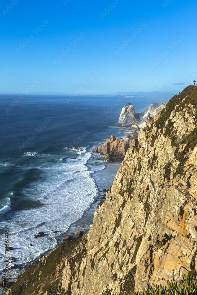 The cape Cabo da Roca in Portugal. Cliffs and rocks at the Atlantic ocean coast in Sintra in a sunny summer day The cape Cabo da Roca in Portugal. Cliffs and rocks at the Atlantic ocean coast in Sintra in a sunny summer day
