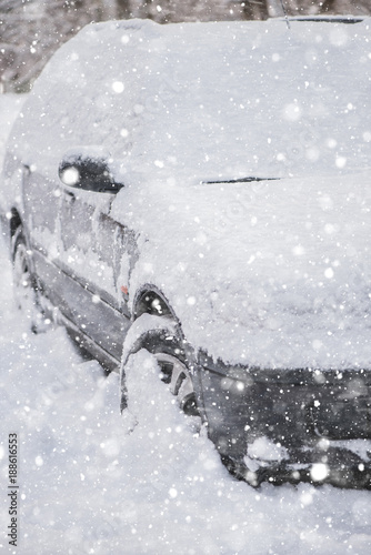 car covered in snow in freezing sub zero temperature heavy snow fall  photo