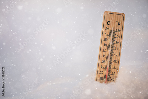 Thermometer in a snow showing freezing low below zero sub zero temperatures
