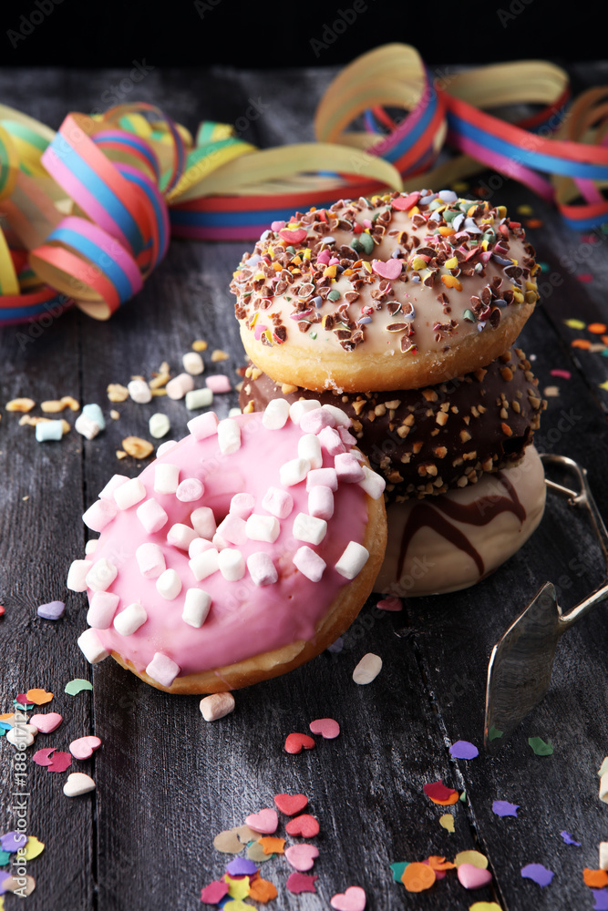 assorted donuts with chocolate frosted, pink glazed and sprinkles donuts. assorted donuts with chocolate frosted, pink glazed and sprinkles donuts.