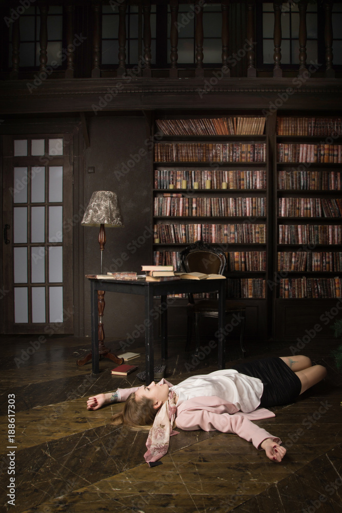 Fototapeta premium Crime scene (imitation). Strangled young student in the classical library