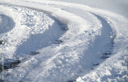 Curved tire tracks in the snow on the road © nd700