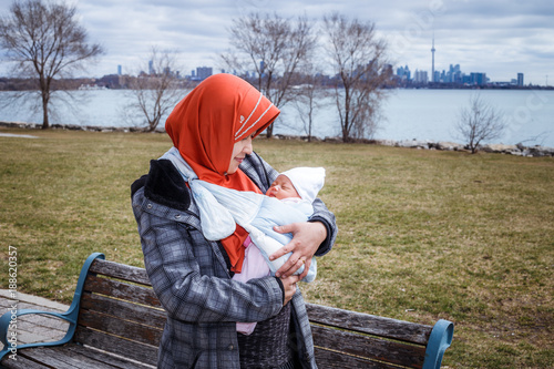 Photography A mother from Indonesia with her newborn baby pose in and around their apartment